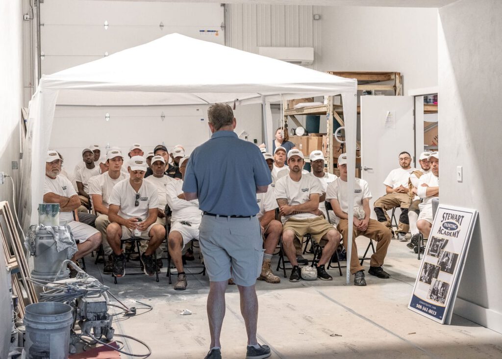 Sheldon Stewart standing in front of employee meeting